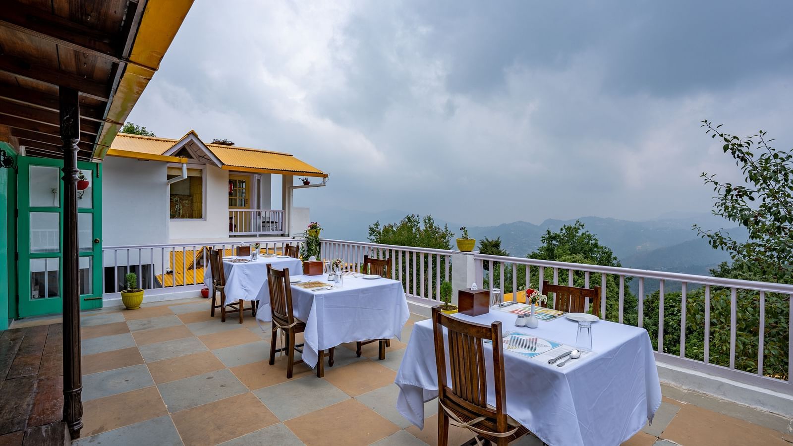 A scenic balcony view of the cloud covered hills.
