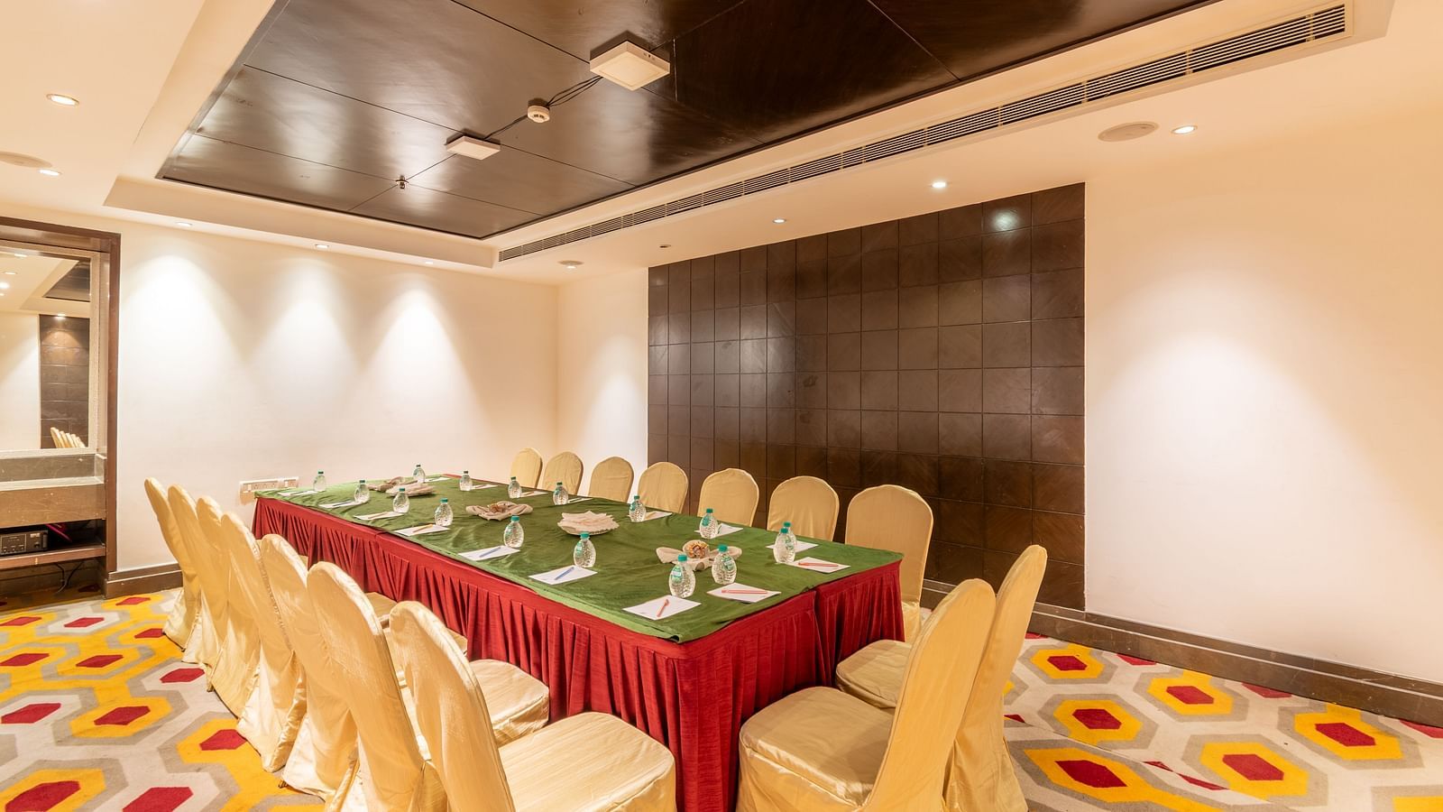 Compact meeting room with U-shaped table arrangement and vibrant carpet flooring- TGI Grand Fortuna, Krishnagiri Main Road, Hosur