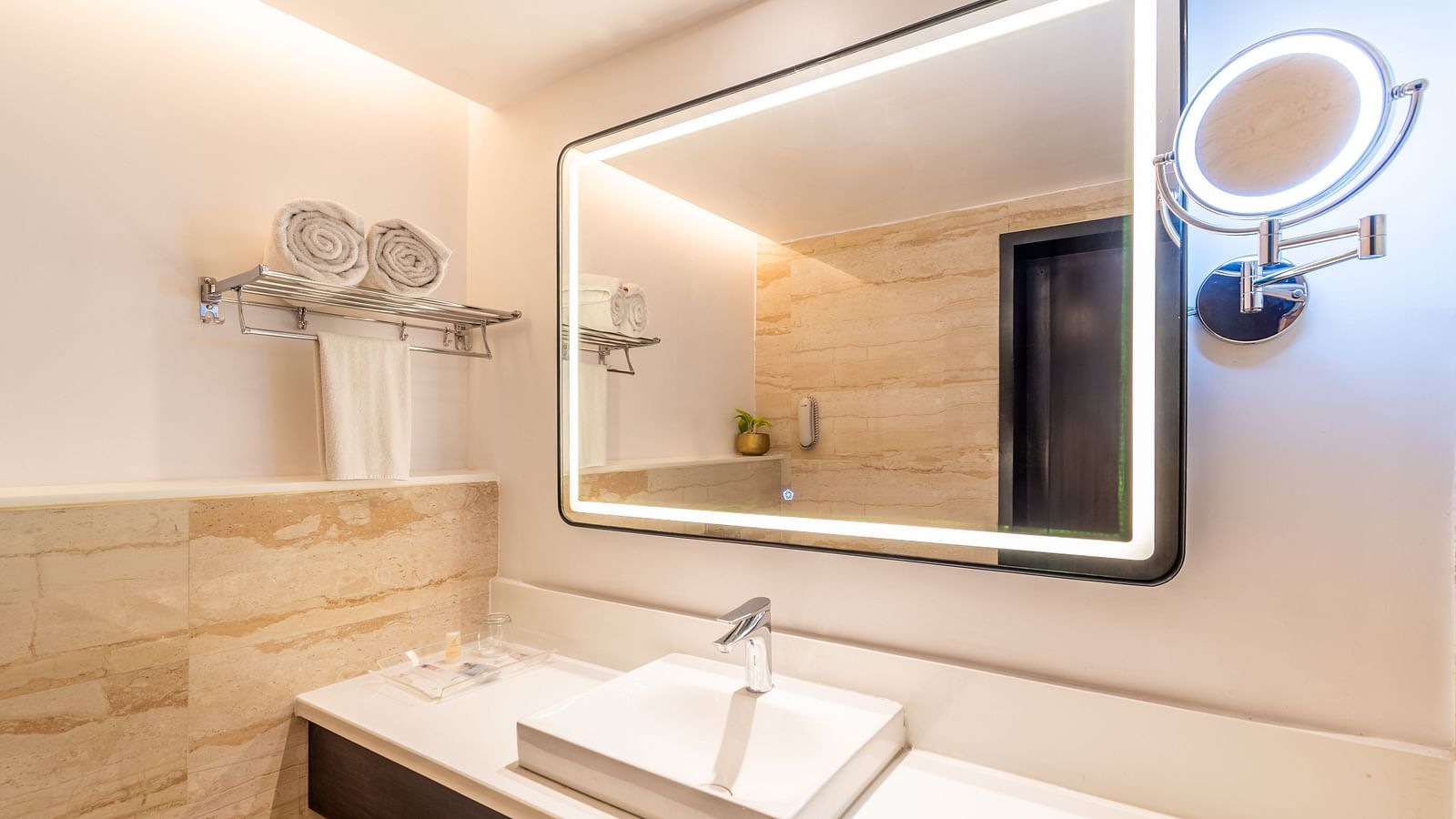 Close-up of bathroom sink with backlit mirror and fixtures- TGI Grand Fortuna, Krishnagiri Main Road, Hosur