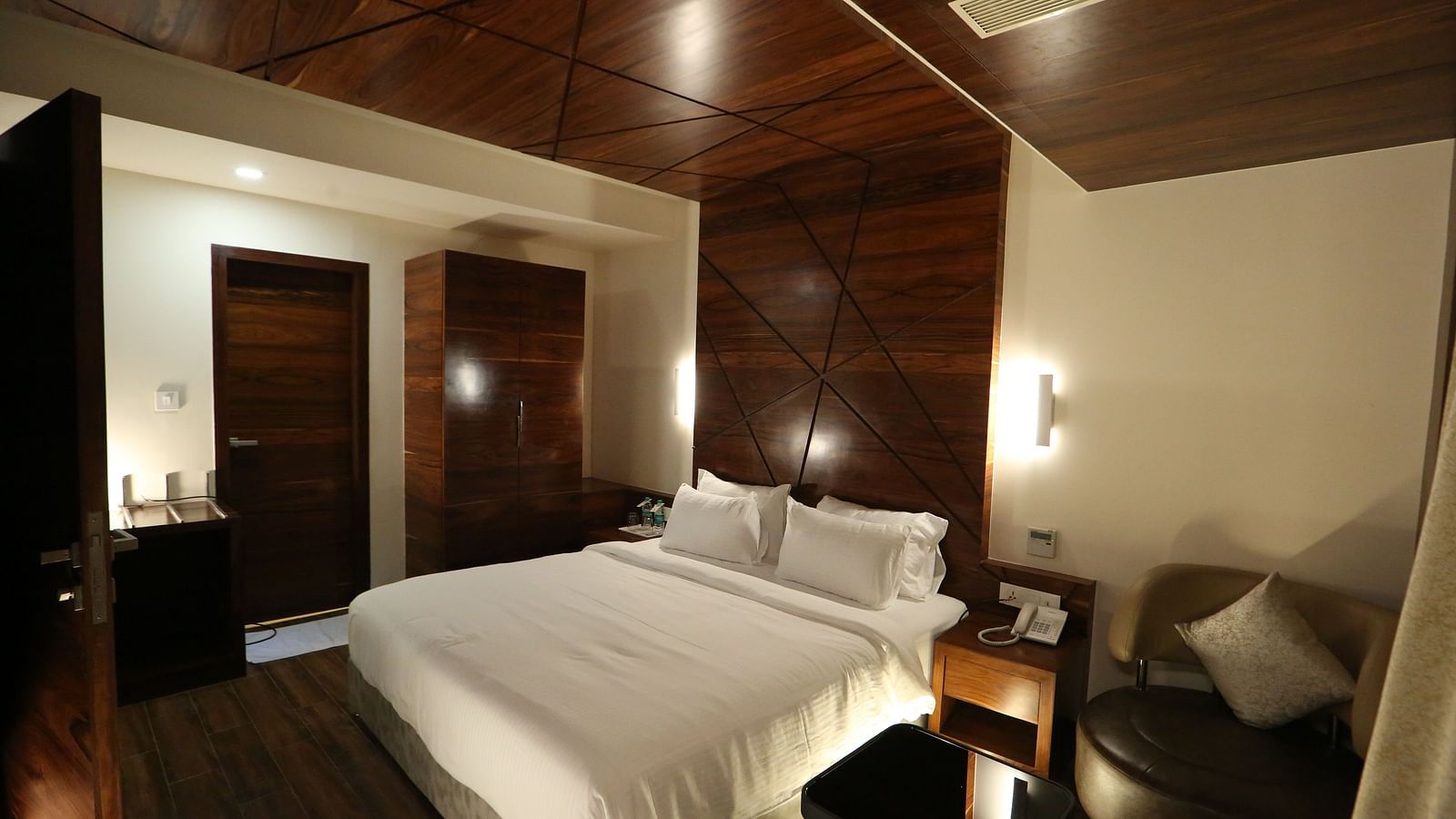 Premium Suite featuring a king size bed and bedside tables. - TGI SPS Grand, Coimbatore