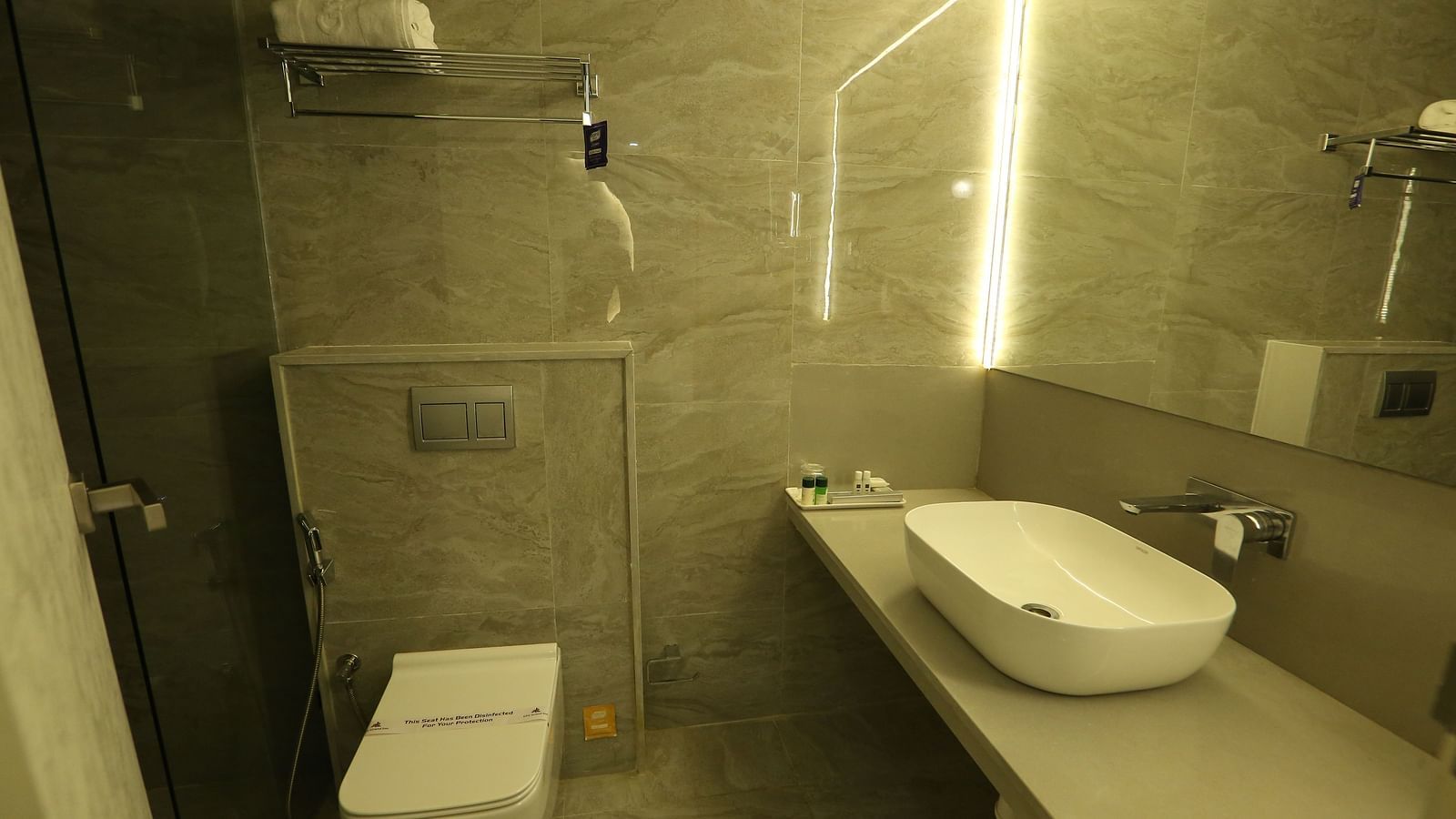 Vanity area of a washroom of Club Suite under ambient lighting - TGI SPS Grand, Coimbatore