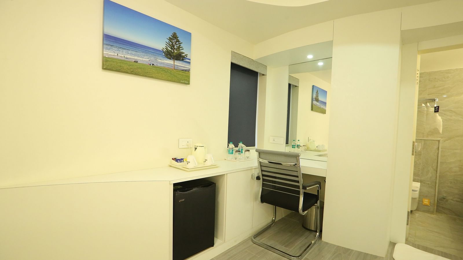 A wider view of Club Suite, highlighting the study table near the washroom - TGI SPS Grand, Coimbatore