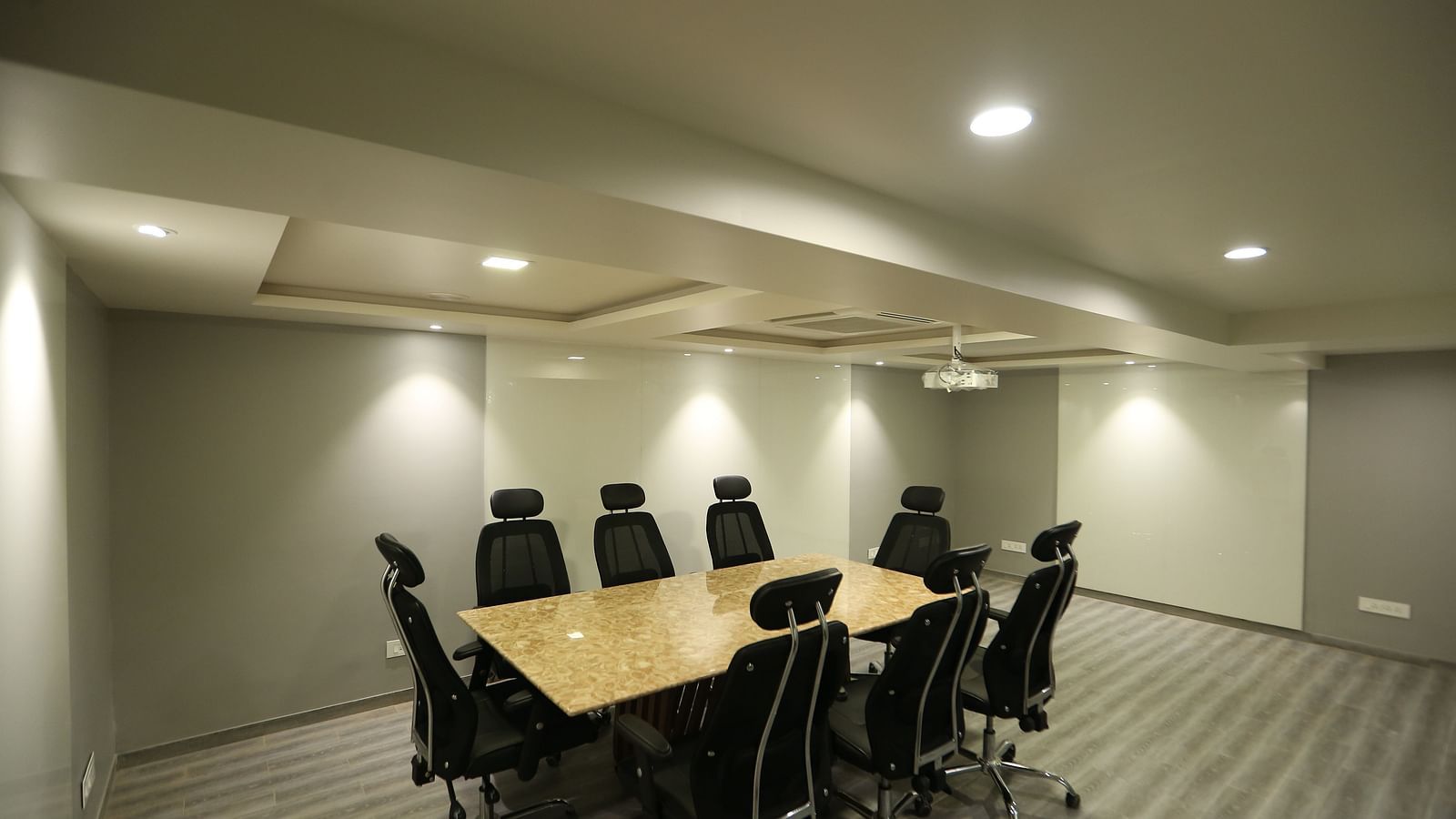 A meeting room setup with a long conference table and chairs - TGI SPS Grand, Coimbatore