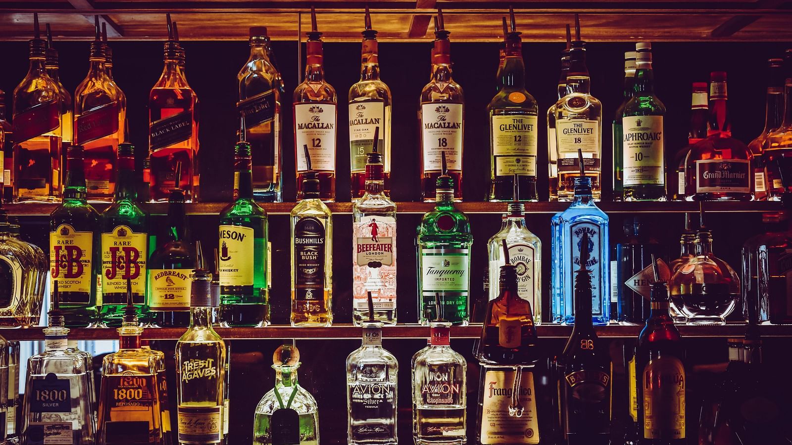 An assortment of wine bottles placed on the counter.