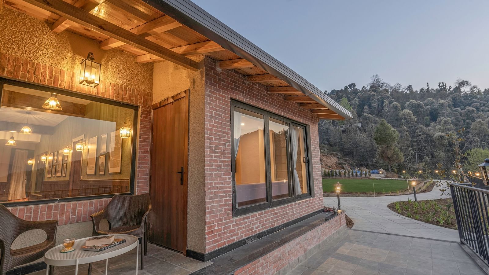Exterior view of a modern building with outdoor seating at The Chamomile Estate.
