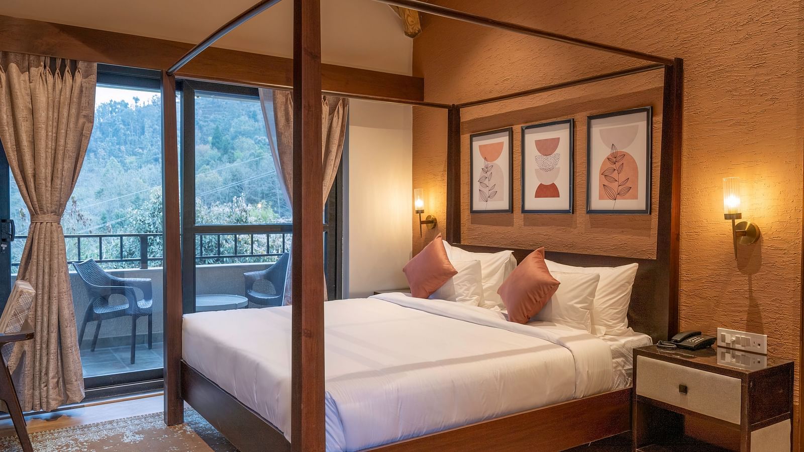 Bedroom with a four-poster bed, bedside table with a wall-mounted light, and a balcony with a view, with curtains pulled to the side at The Chamomile Estate.