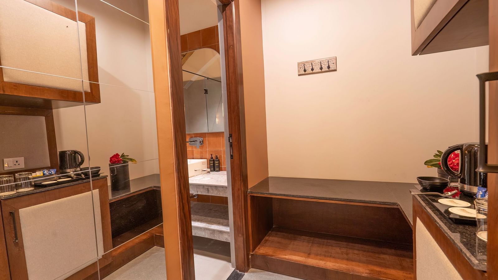 Compact kitchenette area with cupboards and appliances at The Chamomile Estate.