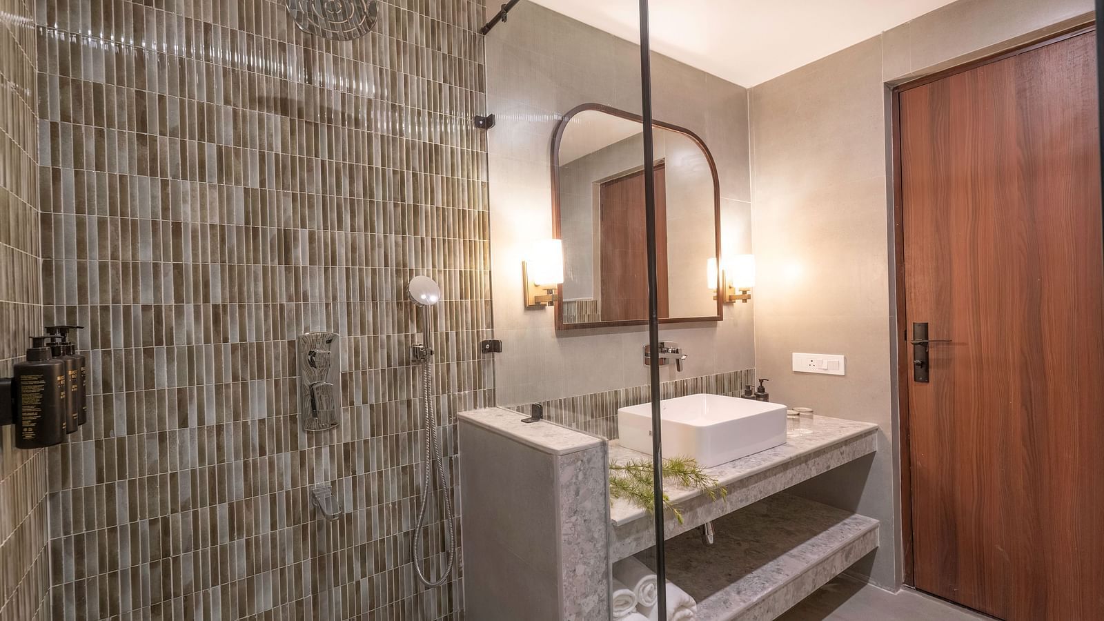 Bathroom with a modern shower and sink, with a wall-mounted mirror above it at The Chamomile Estate.