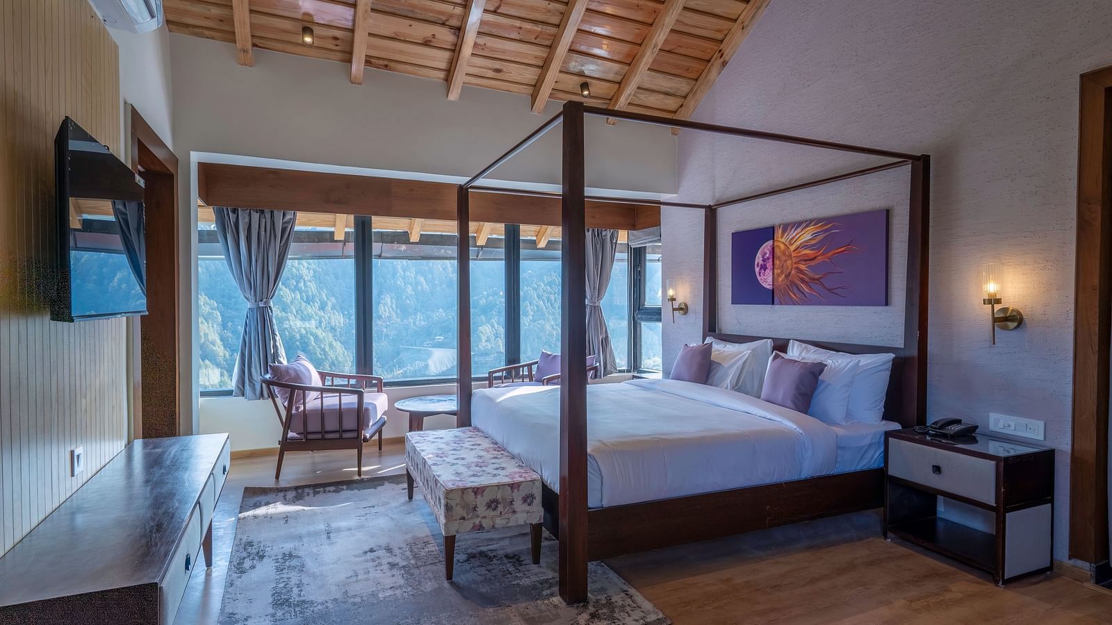 Bedroom with a four-poster bed, bedside table, and large windows offering a view, and a desk positioned below a wall-mounted television at The Chamomile Estate.