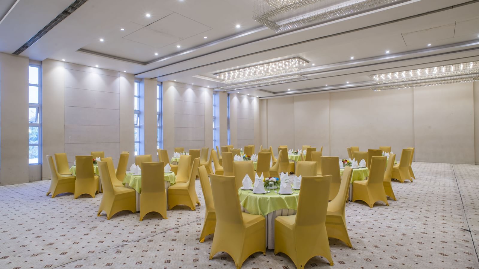A large meeting room with yellow chairs at The Citi Residence Hotel, Asansol.