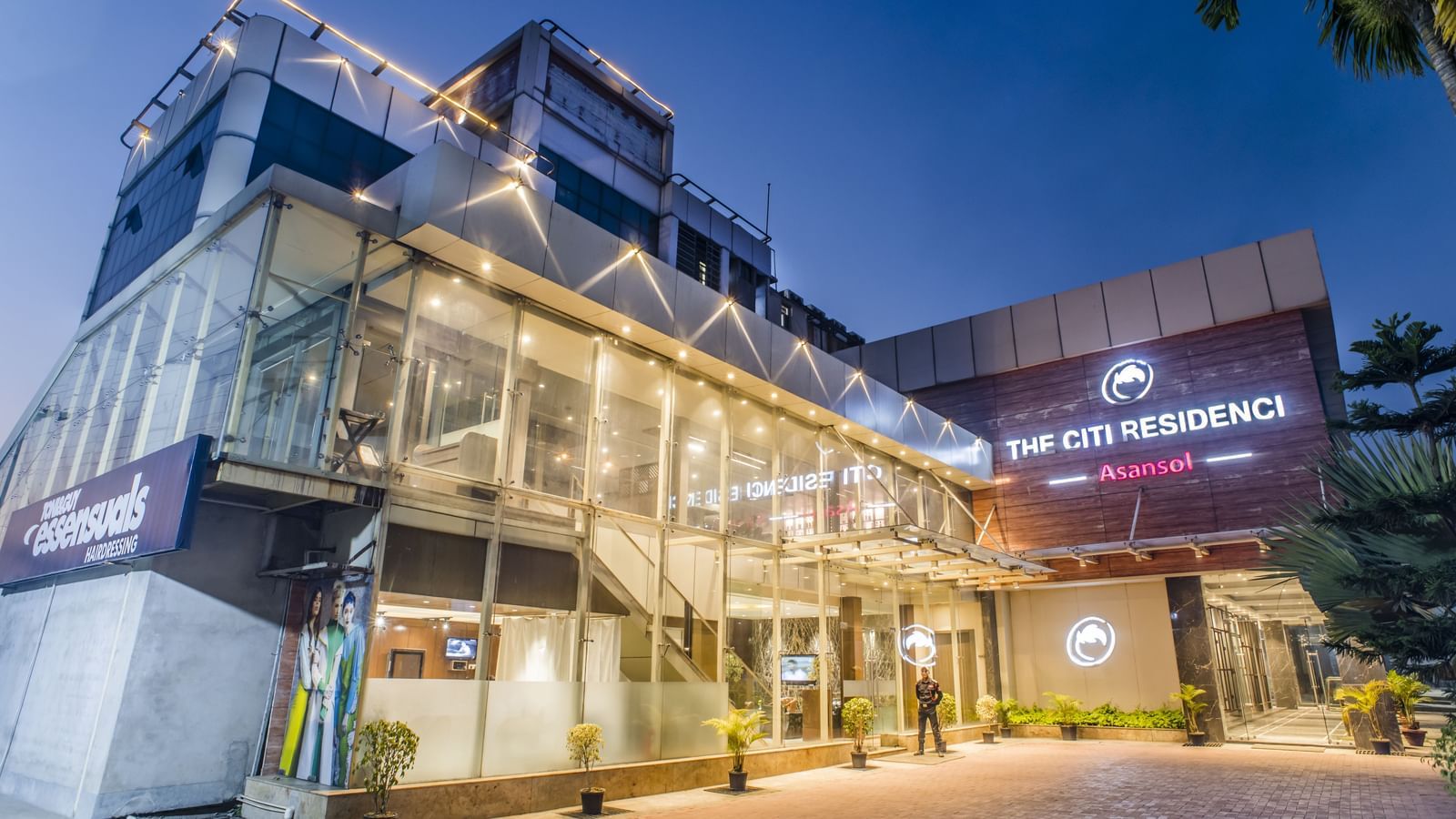 The exterior of The Citi Residenci Hotel, Asansol, at dusk with lights on.