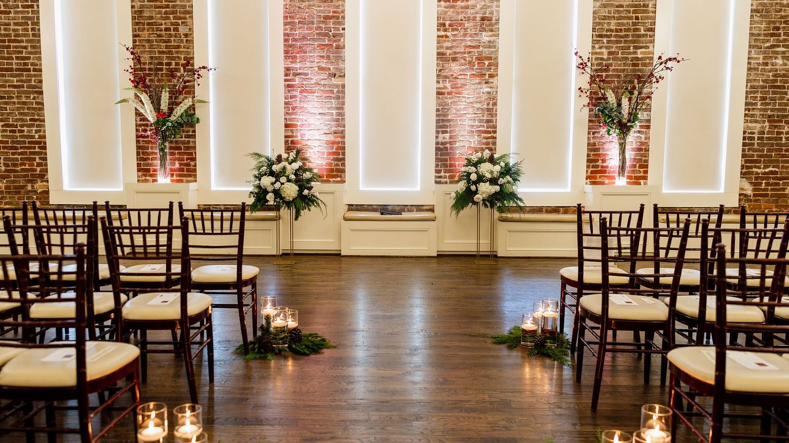 A well-decorated event space with empty chairs arranged in theater style setting - The Grand Hotel & Ballroom, McKinney