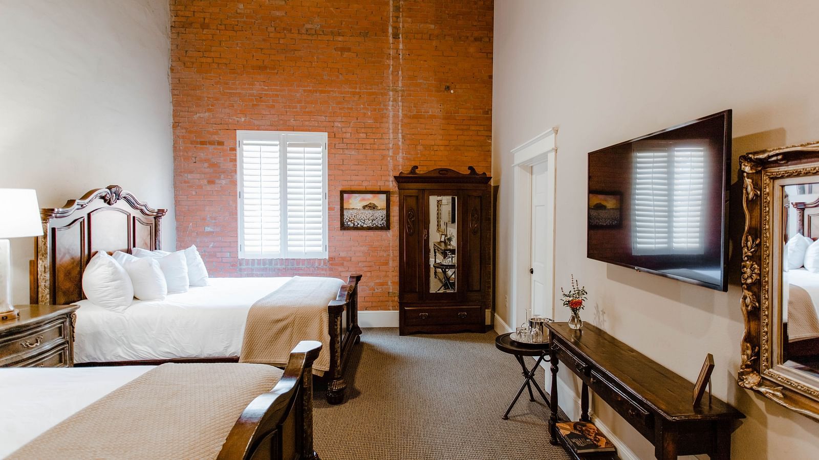 A charming bedroom with wooden furniture, elegant decor, and a ceiling fan, offering a serene and classic atmosphere - The Grand Hotel & Ballroom, McKinney