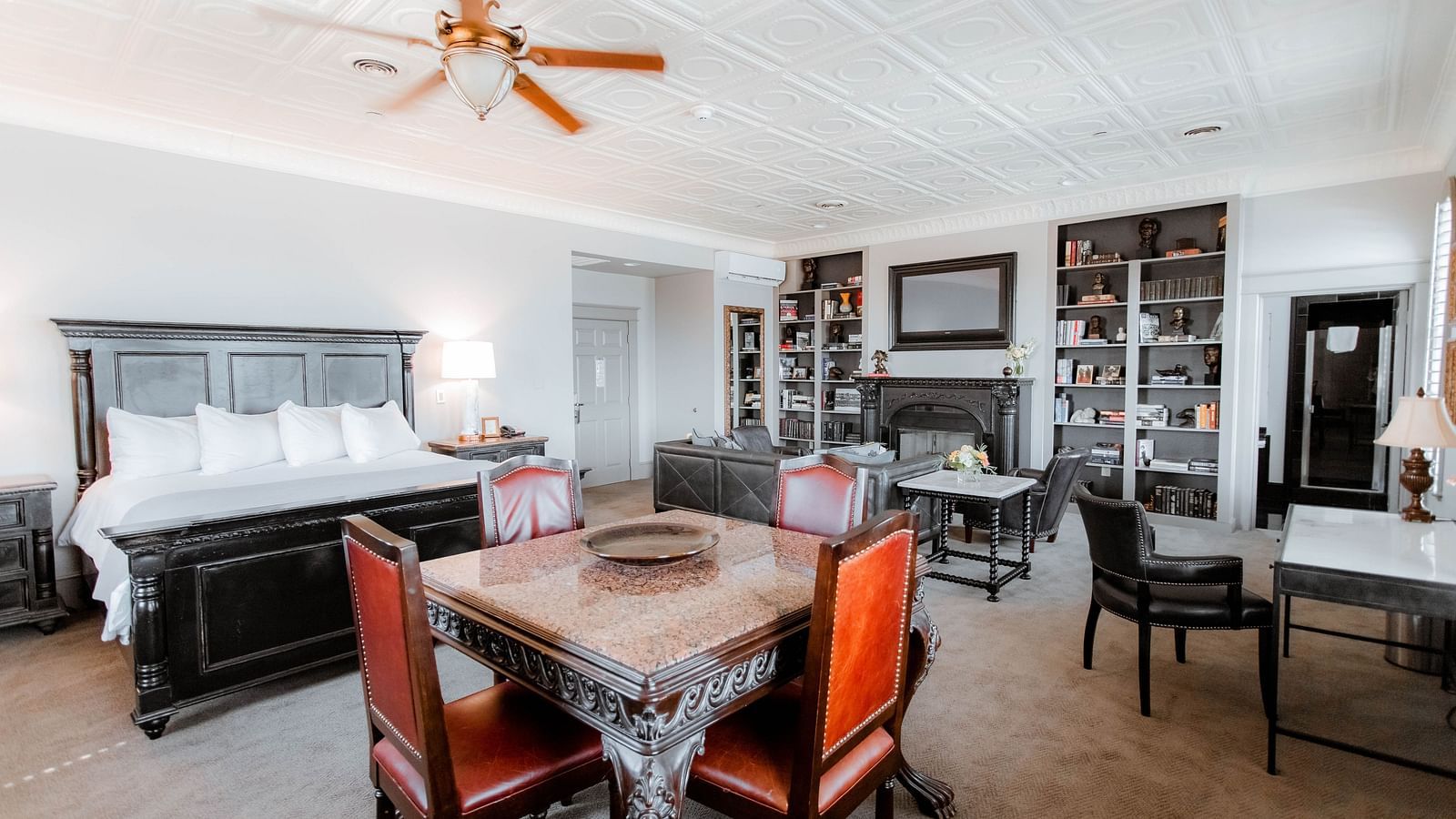 A dining area featuring a wooden table, comfortable chairs, and tasteful decor, offering an inviting place to enjoy meals - The Grand Hotel & Ballroom, McKinney