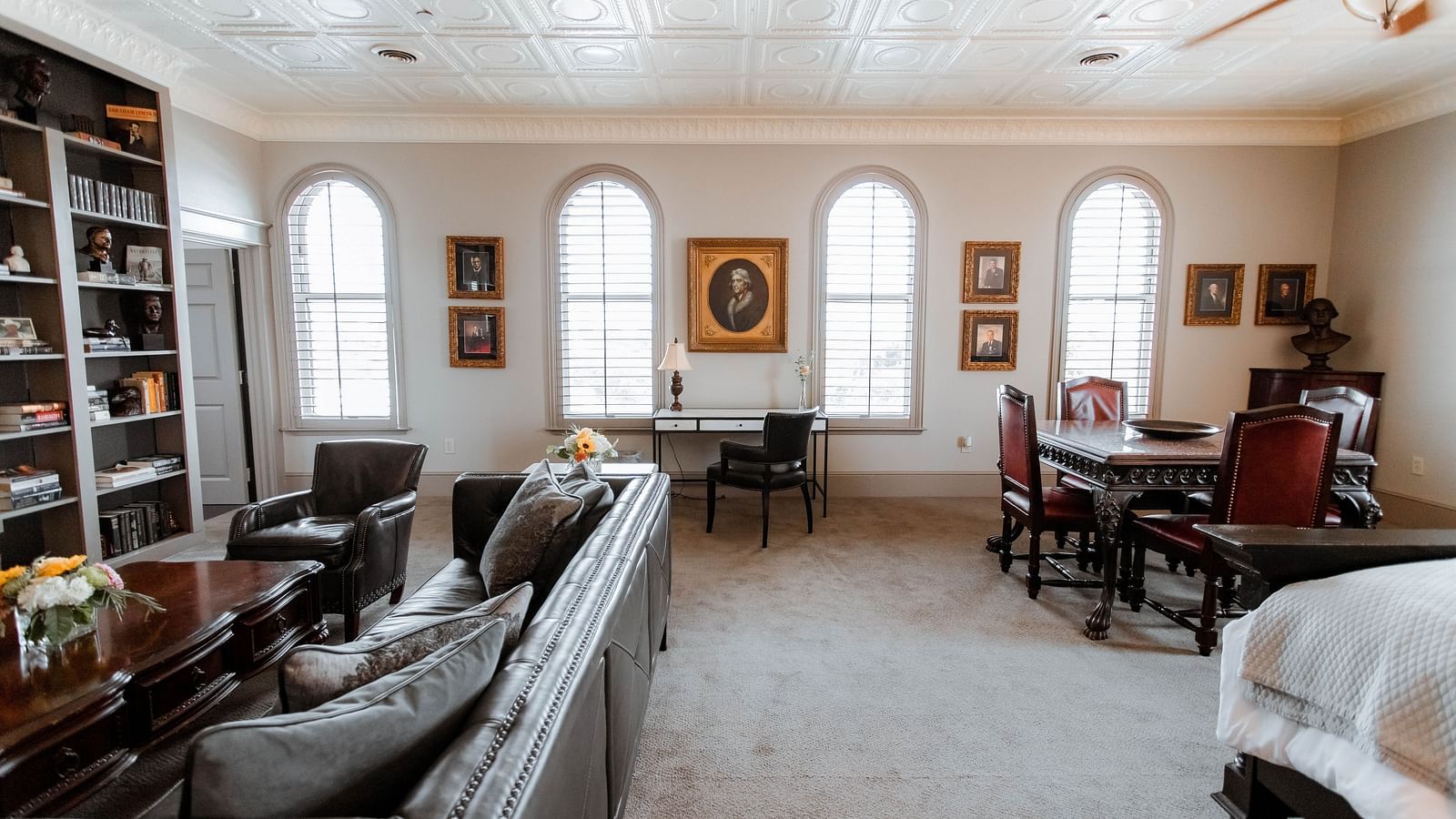  A spacious bedroom with a king-sized bed, wooden furniture, and soft lighting, creating a tranquil and elegant retreat - The Grand Hotel & Ballroom, McKinney