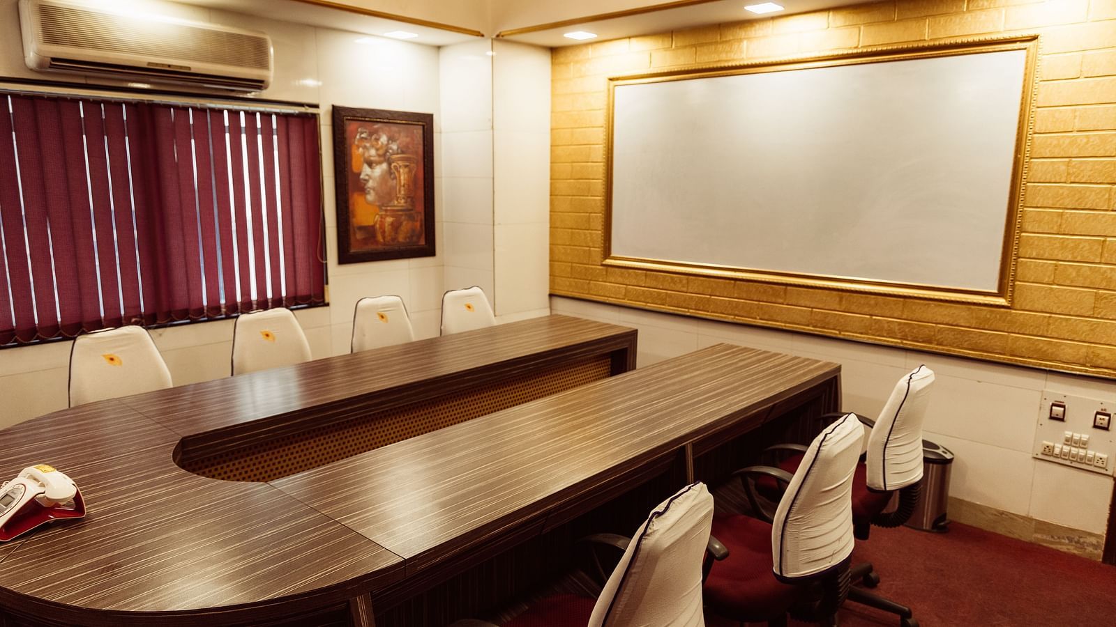 image of the boardroom at The Grand Krishna Rooms featuring a projector screen in far end of the room