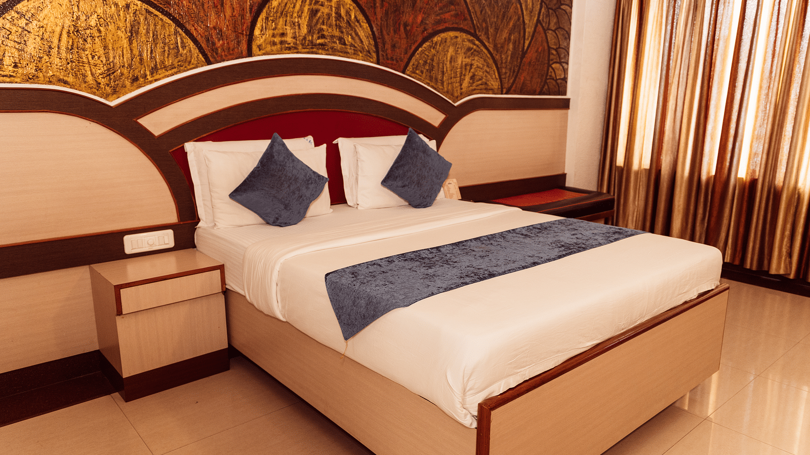 image of a comfortable double bed in the executive room at The Grand Krishna Rooms in Bengaluru