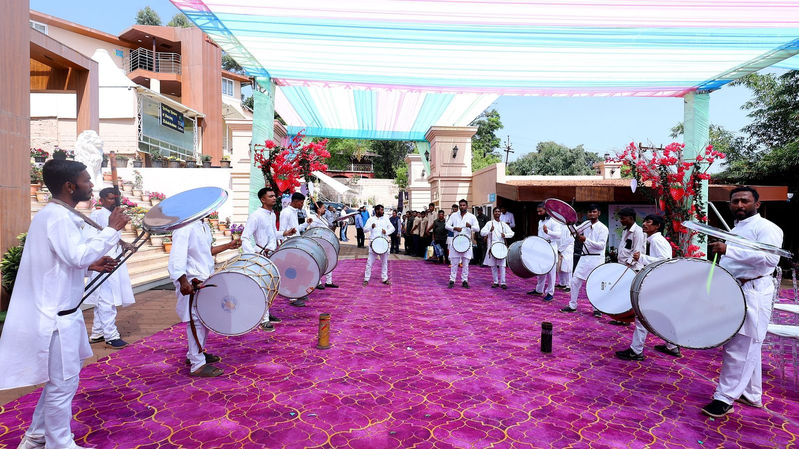 A group of musicians carrying drums to play at a wedding function at The Grand Legacy Resort & Spa