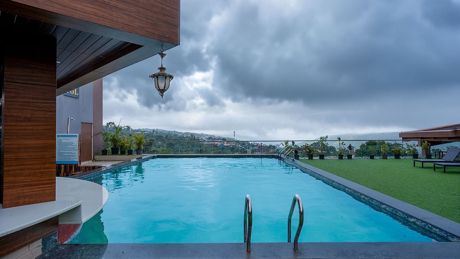 Shot of a expansive swimming pool with a backdrop of a clear sky | The Grand Legacy Resort and Spa