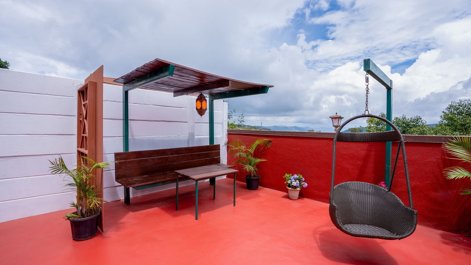 Image of a outdoor sit-out with a small swing and a seating area | The Grand Legacy Resort and Spa