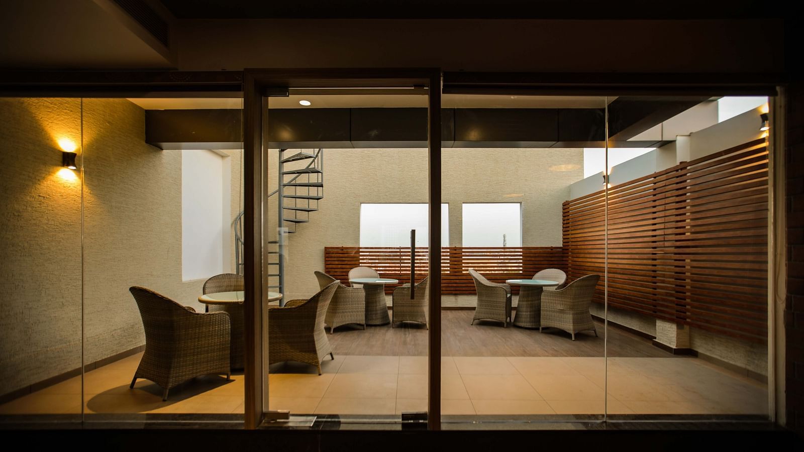 lobby with comfortable seating and warm a staircase of The Mayberry, Tiruppur