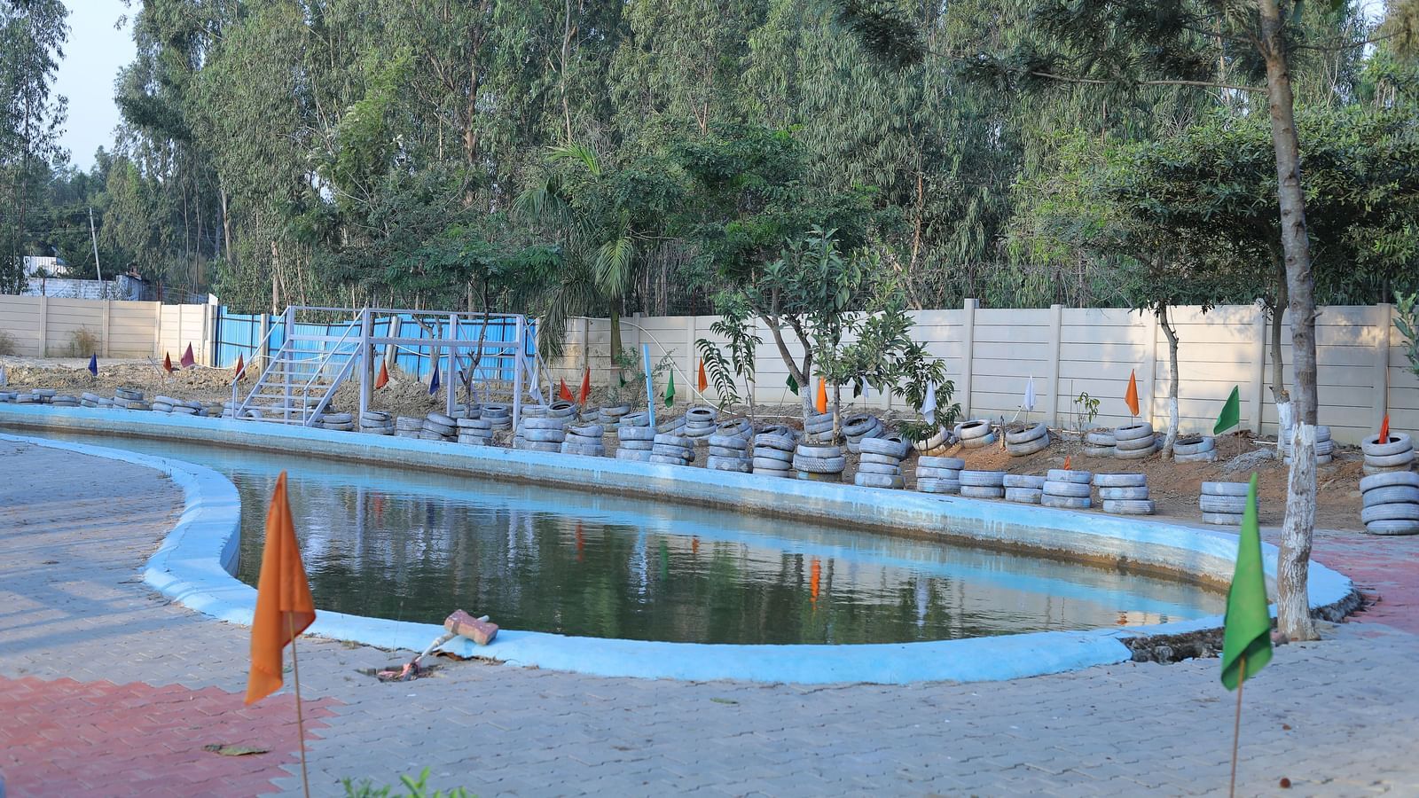 A swimming pool area at The Meenakshi Resort by Welcome Inn Hospitality, Bangalore.