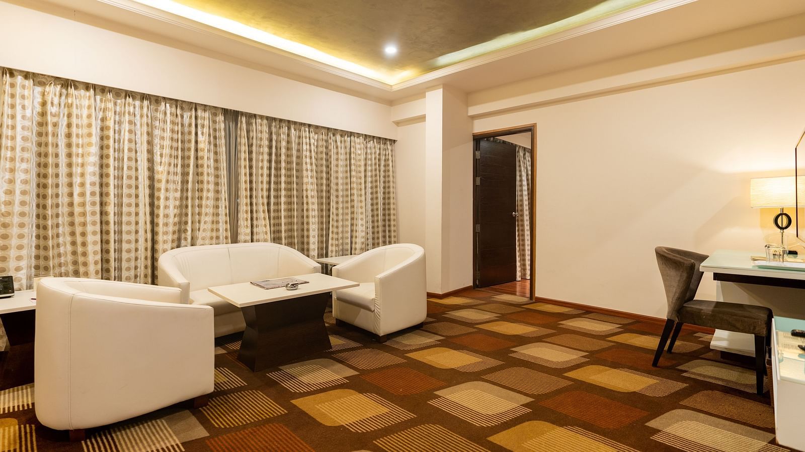 Club Suite with a sofa set and table at The President Hotel, Hubli