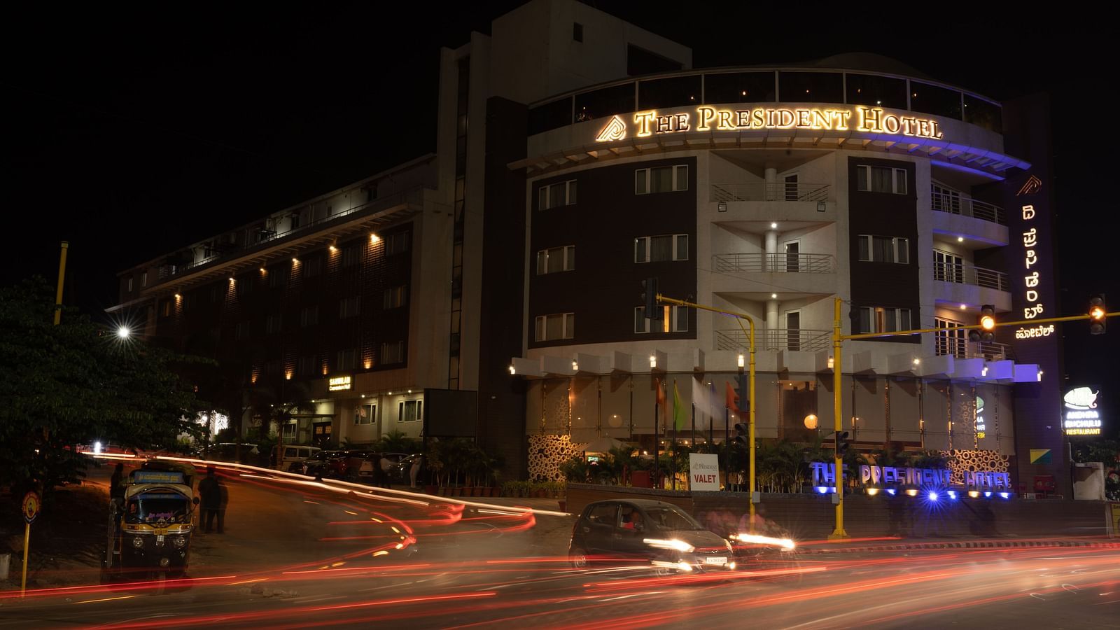 A stunning image of the facade of The President Hotel, captured at night with city lights.