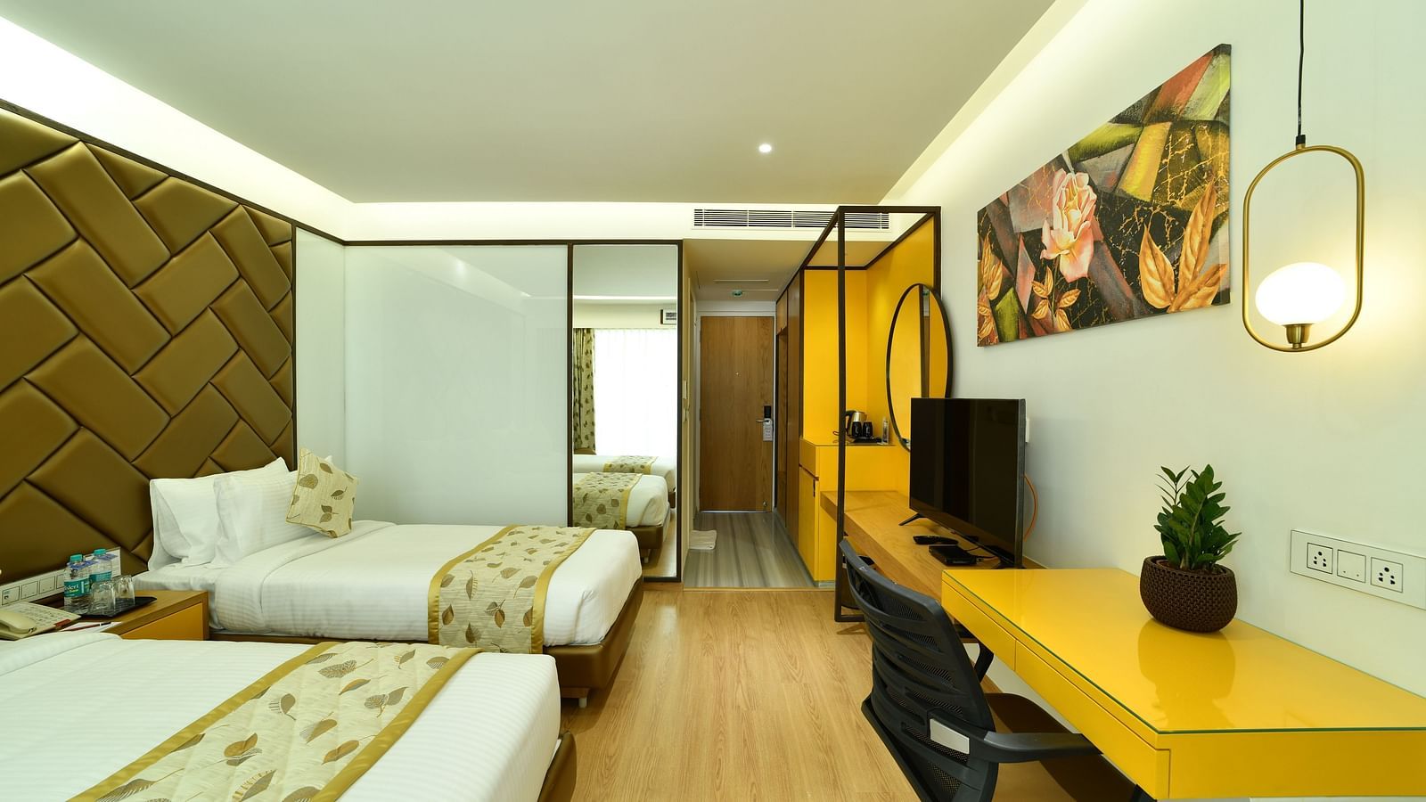 An image of twin beds in a bedroom with a work desk and a chair - The President Hotel, Kumara Park, Bangalore