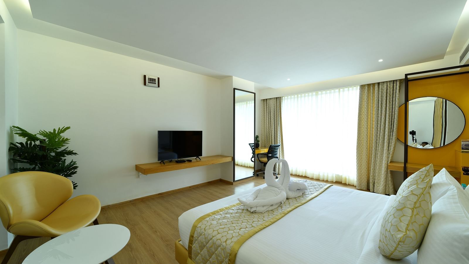 An image of side view of a bedroom with a television facing the bed - The President Hotel, Kumara Park, Bangalore