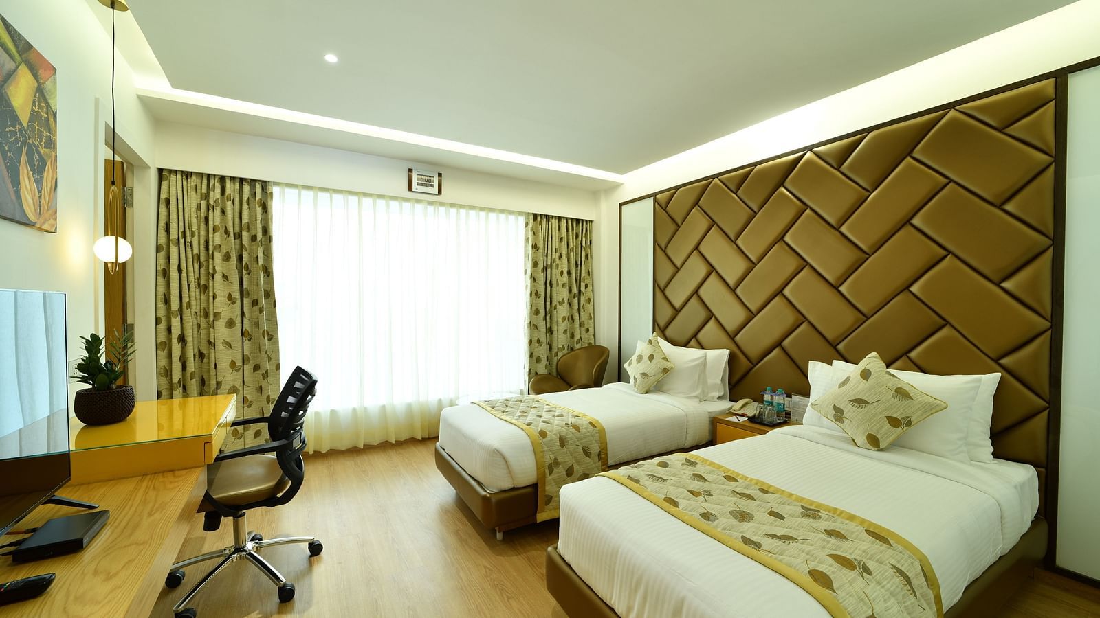 An image of a bedroom with twin beds and a television - The President Hotel, Kumara Park, Bangalore