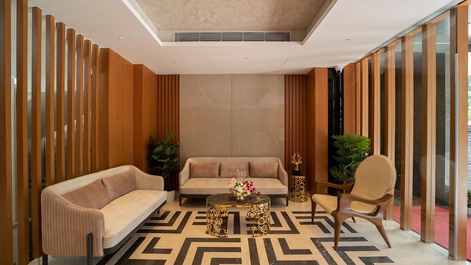 An image of hotel lobby area with geometric patterned flooring and sofas - The President Hotel, Kumara Park, Bangalore