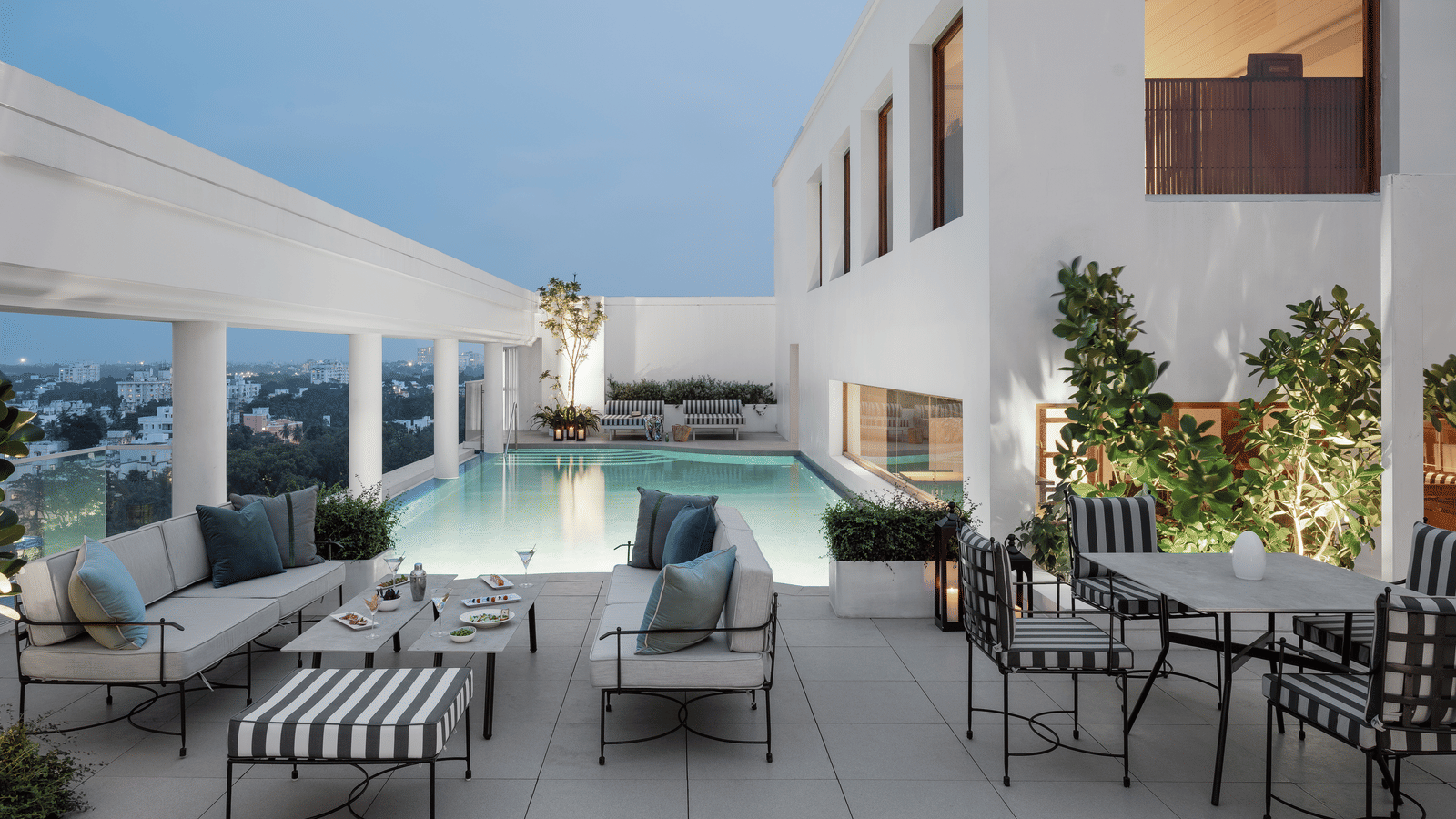 An inviting outdoor terrace with a swimming pool, ideal for relaxing and socialising at The Raintree, St. Mary's Road