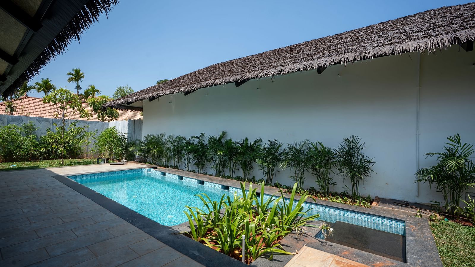 The swimming pool of the Exotic Pool Villa with plants around it at The Shore Trishvam.