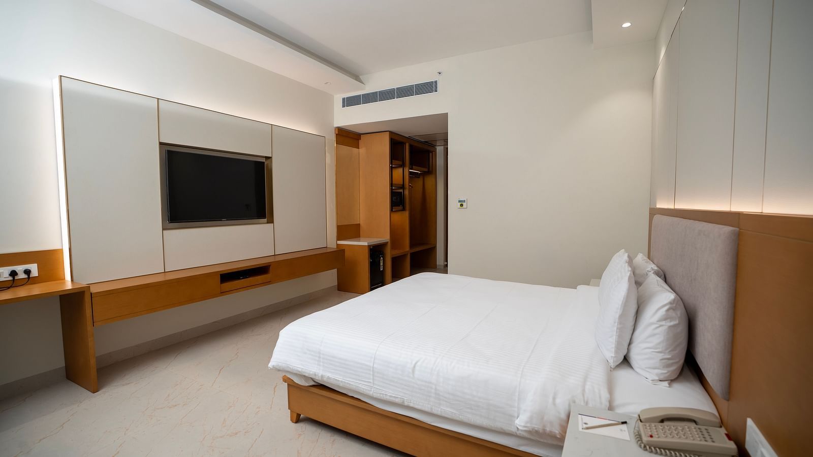 Corner view shot of the Garden Courtyard room featuring a double bed and a flat screen television at The Shore, Trishvam.