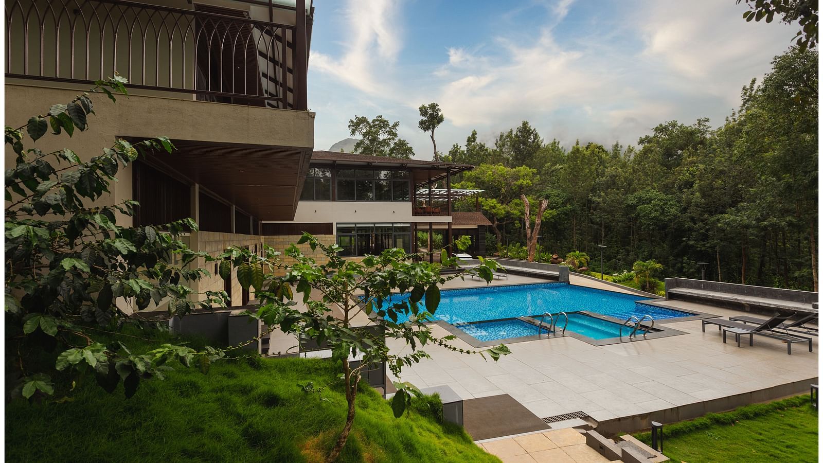 corner view of the iproperty showing pool and buildinf