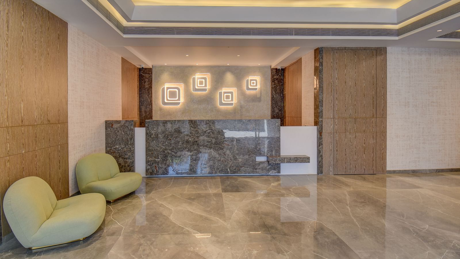 A luxurious lobby at a hotel with reception desk, ambient lighting and sofa | The SSK Solitaire Boutique Hotel & Spa, Gangapur Road - Nashik