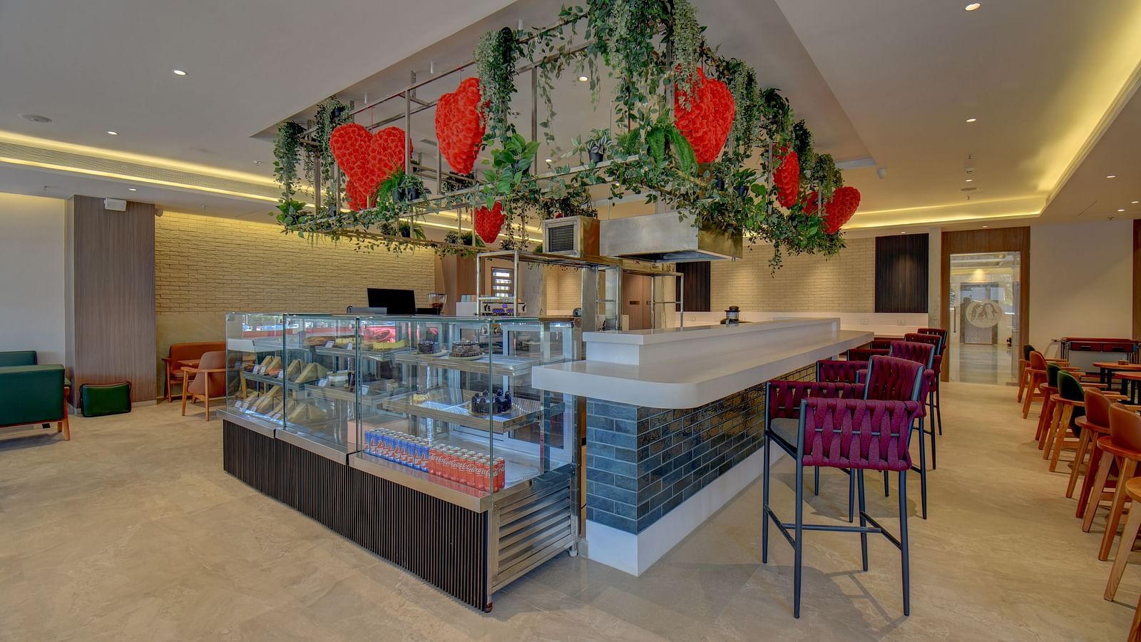 Side view of two sister's cafe The SSK Solitaire Boutique Hotel & Spa, Gangapur Road - Nashik featuring baked goods and chairs.
