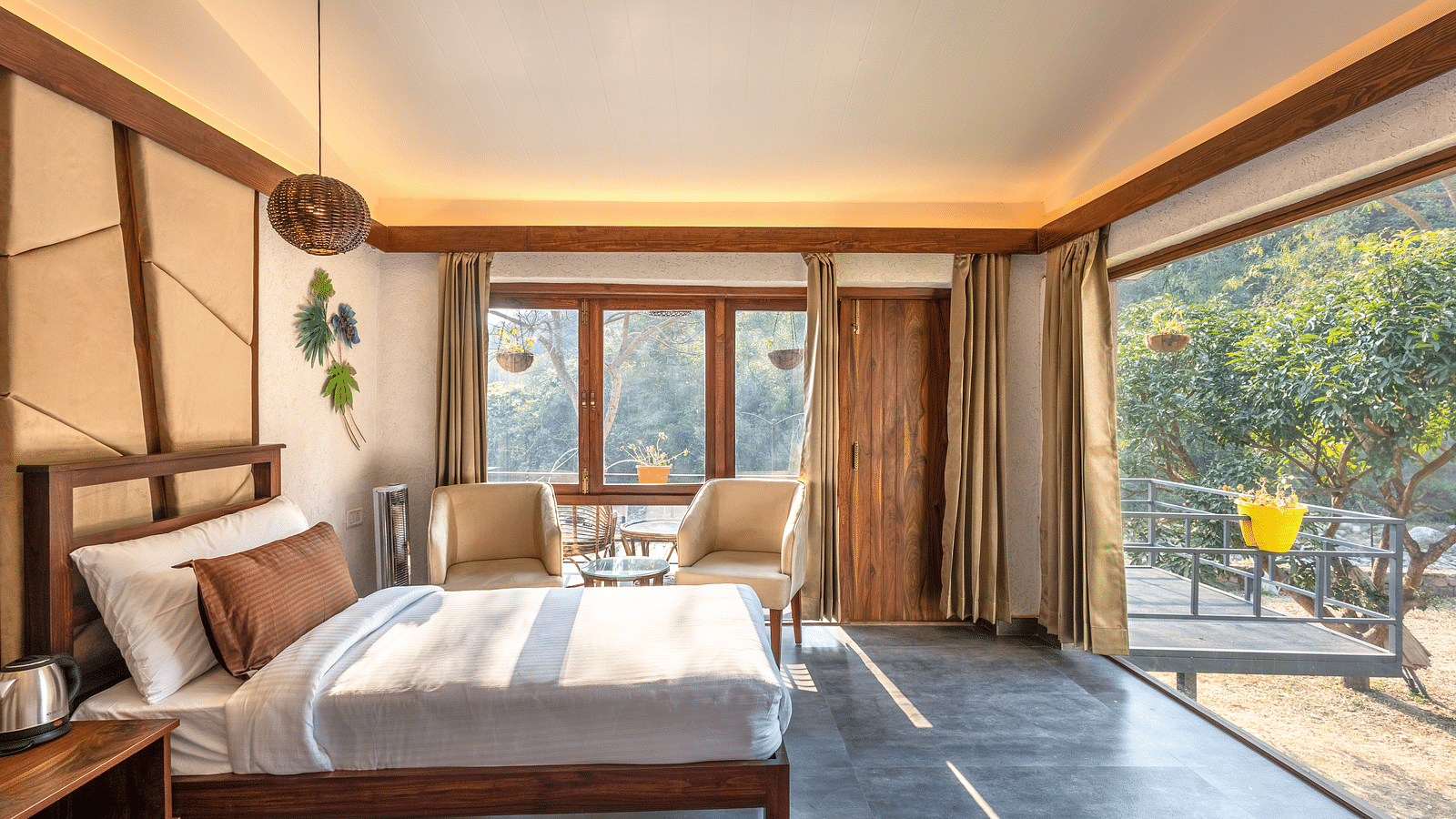 A small placed next to the chairs of River View Room at the Sylvan Retreat, Dehradun.