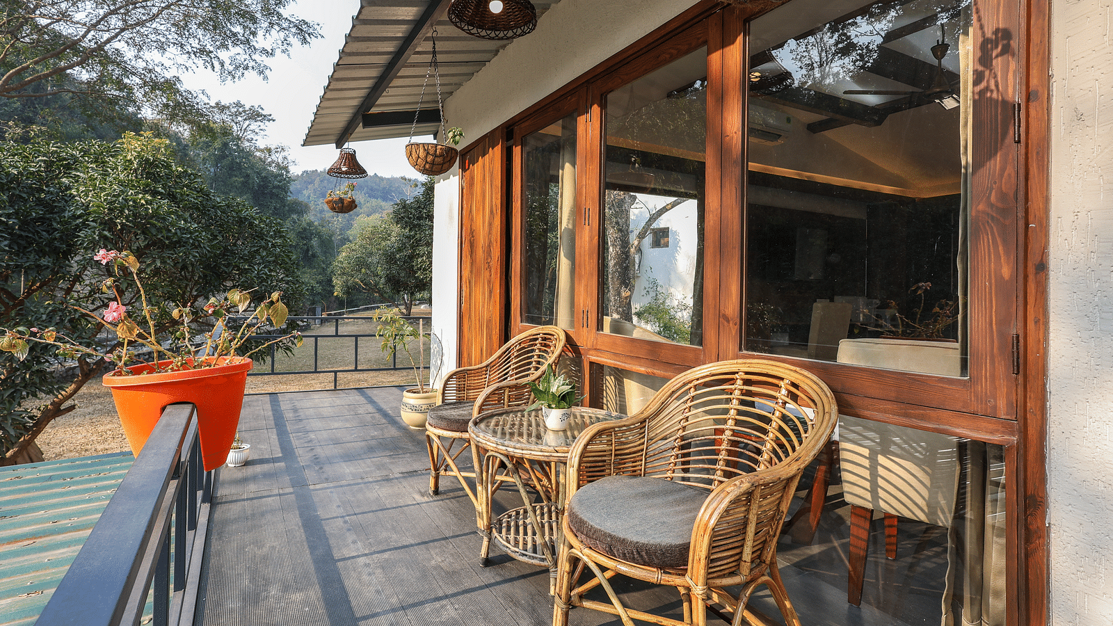 The balcony with chairs facing the view of River View Room at the Sylvan Retreat, Dehradun.