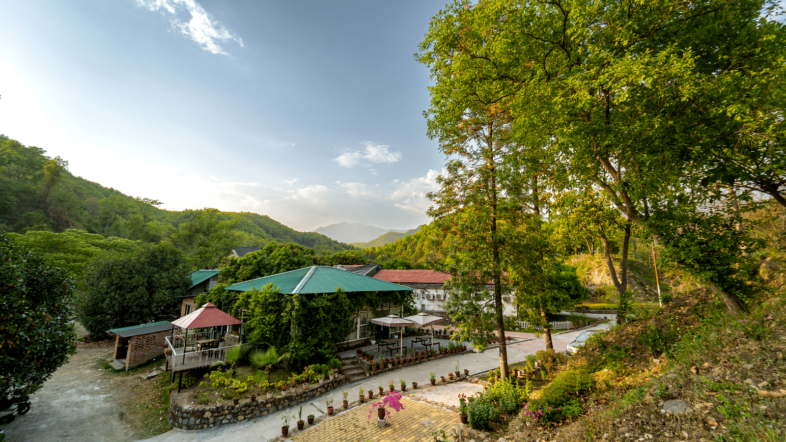 An exterior view of The Sylvan Retreat, Dehradun amongst greenery.