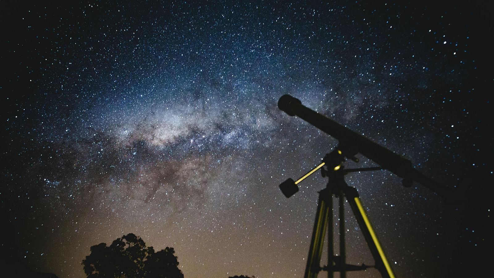 A telescope under the sky at night.