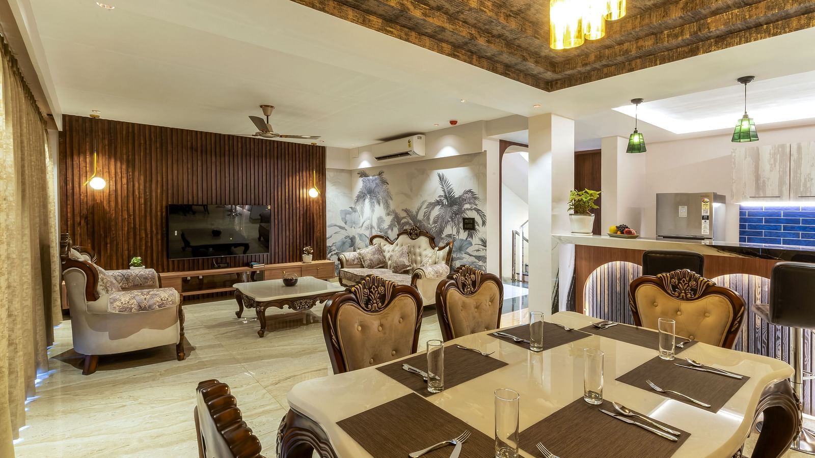 the living room with sofas and a dining table inside one of the rooms - The Tanisi Hotels & Resorts, Goa