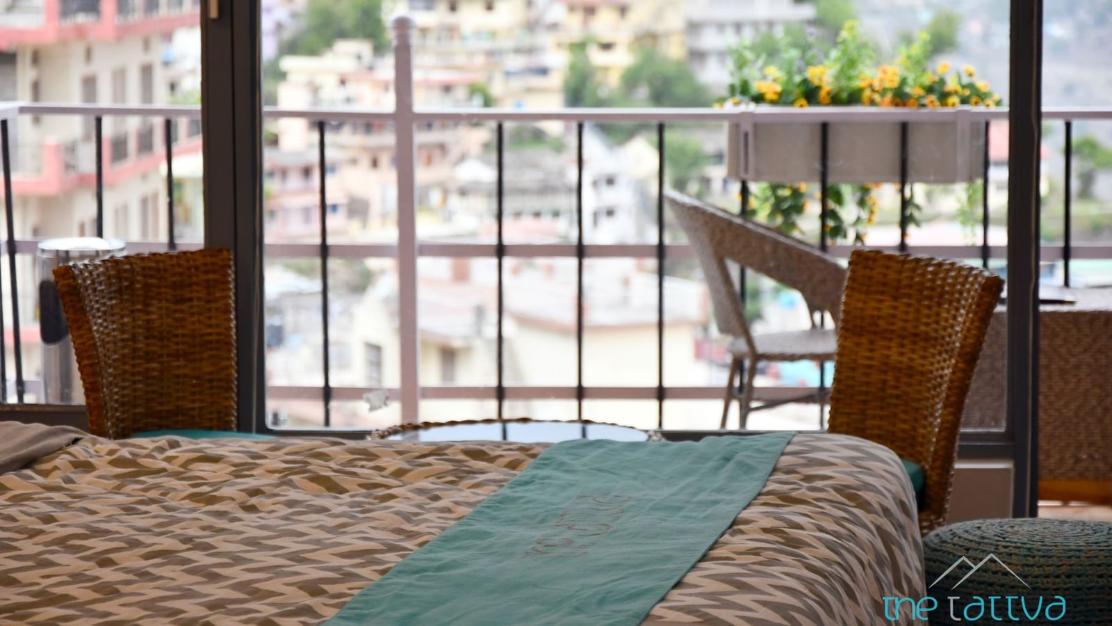 Close up of a bed in the premium room over looking the views from the balcony - The Tattva Boutique Resort
