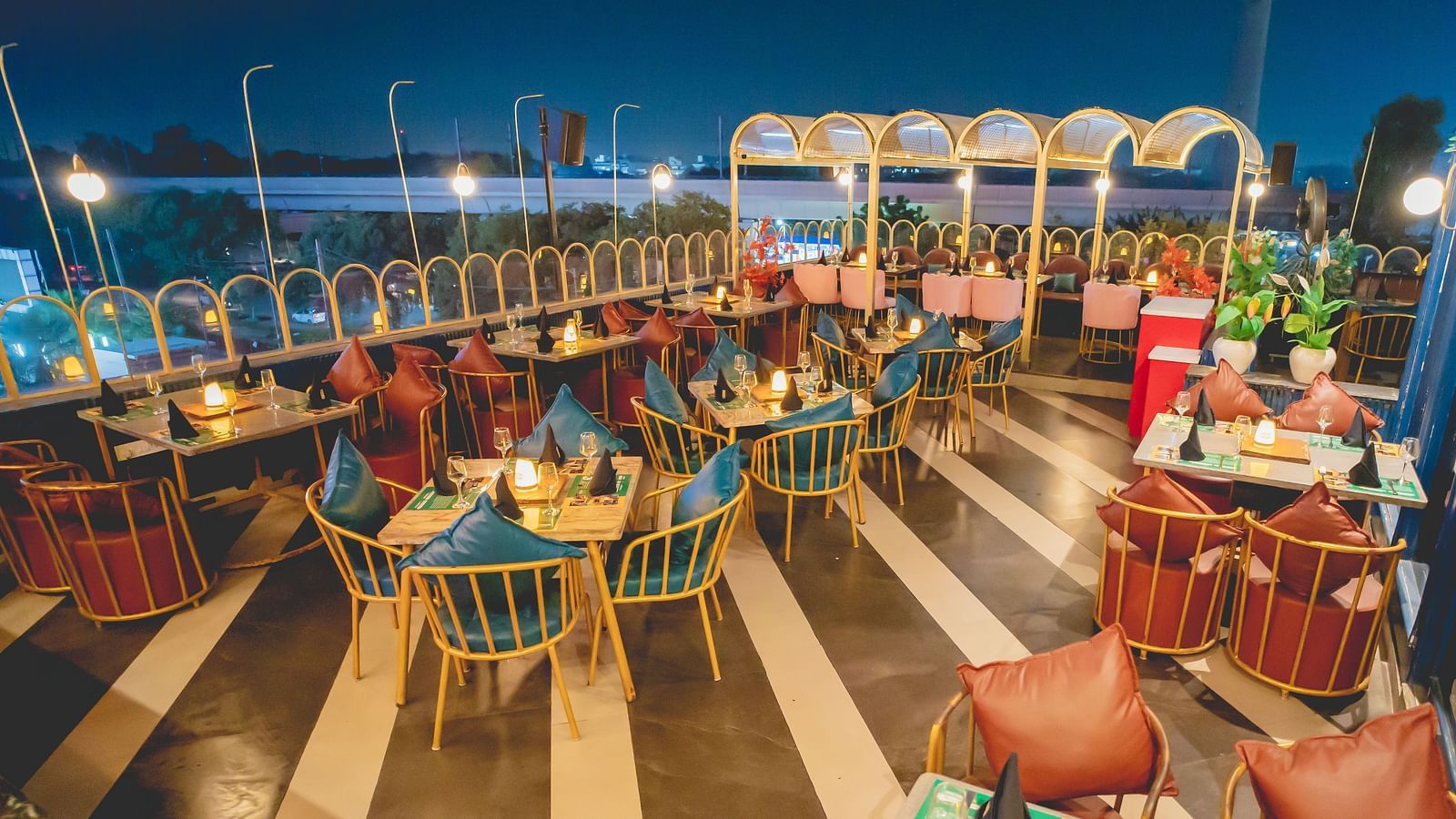 An image of a rooftop restaurant with several chairs and tables at Themis Barbecue House, NSP Pitampura