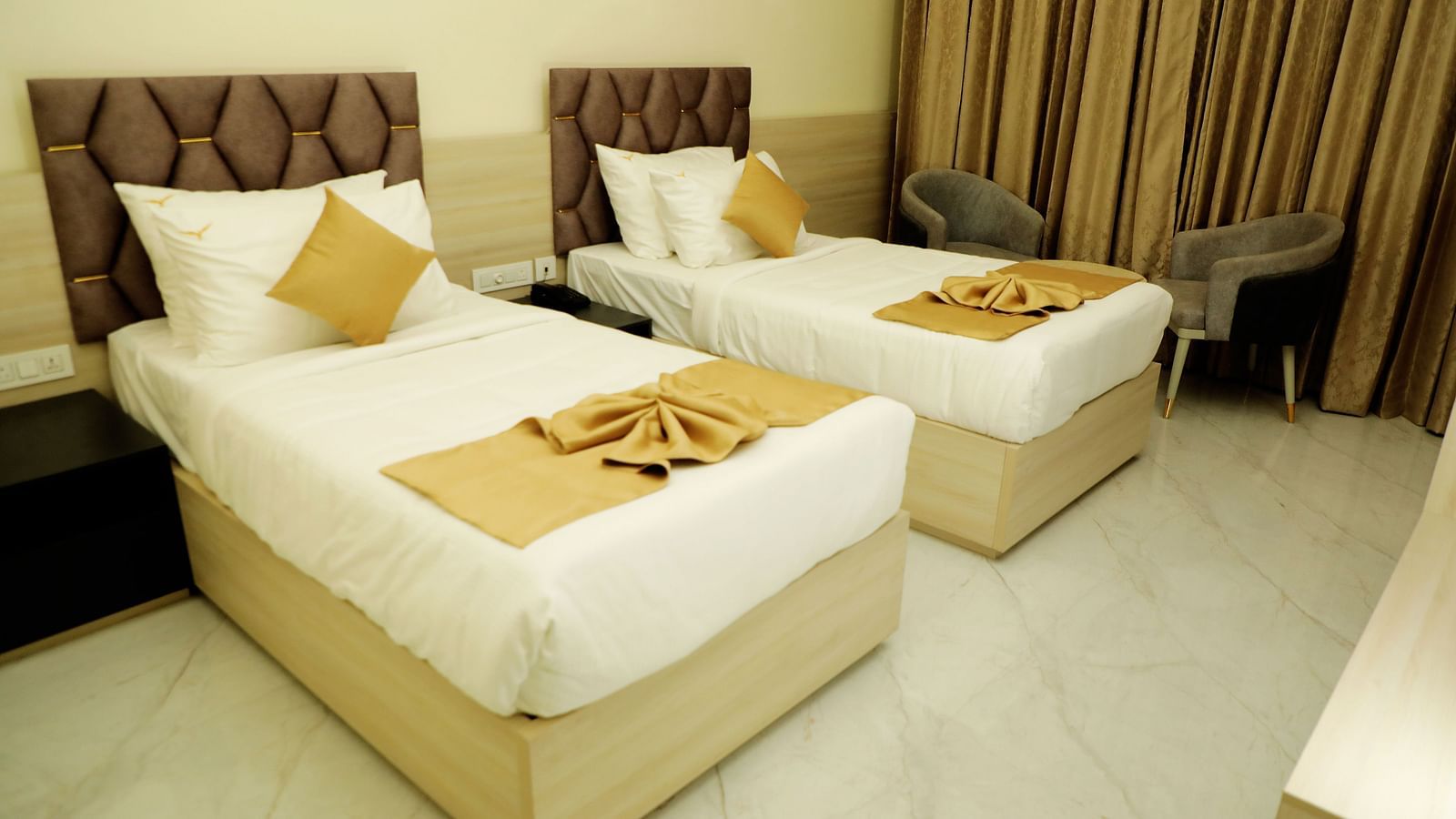 Twin bed deluxe room at Town Square Suites featuring elegant furnishings and cozy ambiance