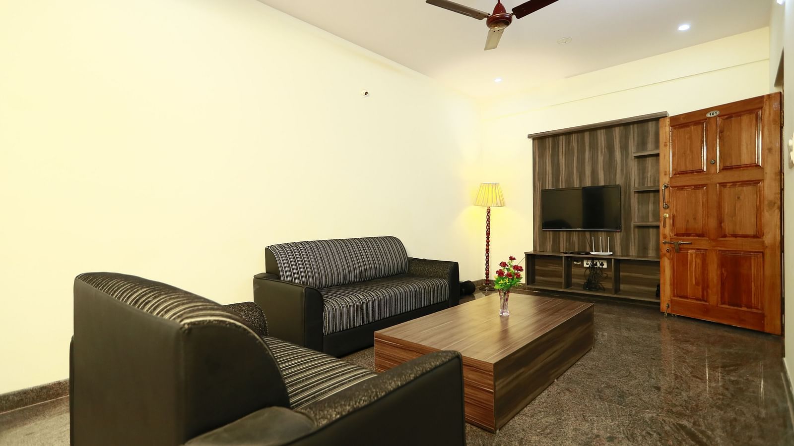 Living area with sofa seating and a coffee table at Tranquil ABS Orchid Serviced Apartments.
