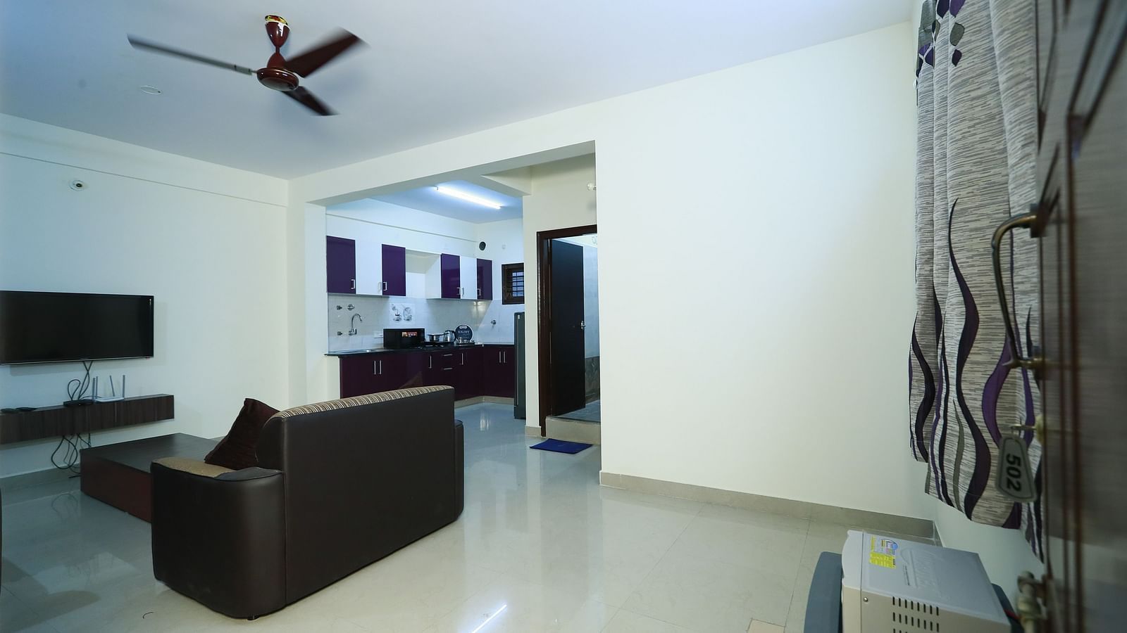 Living area with sofa seating and a coffee table at Tranquil ABS Orchid Serviced Apartments.