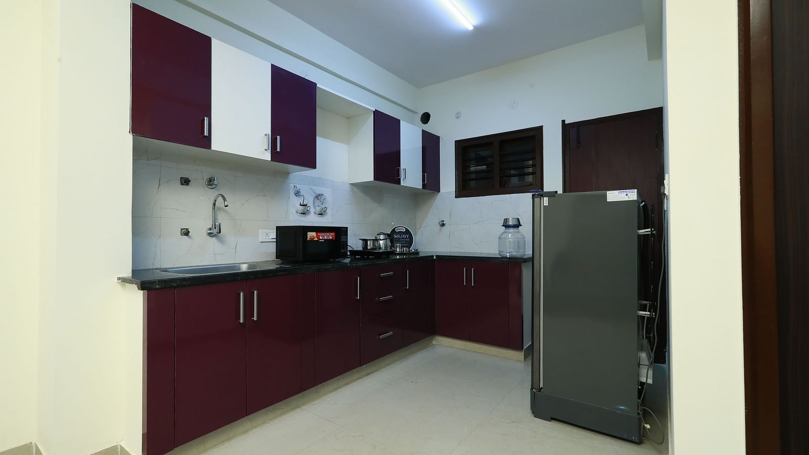 A fully equipped kitchenette at Tranquil ABS Orchid Serviced Apartments