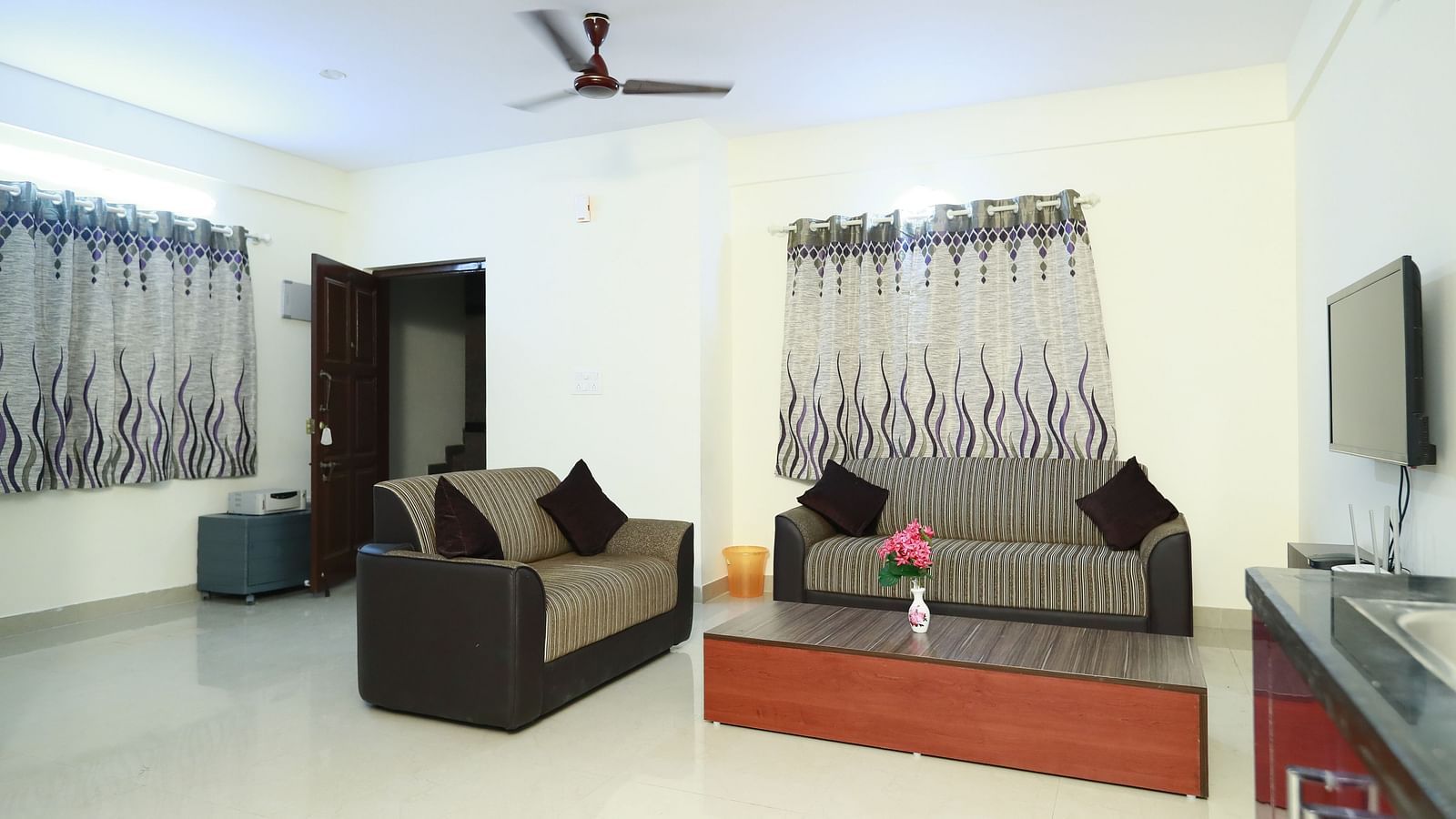 Living area with sofa seating and a coffee table at Tranquil ABS Orchid Serviced Apartments.